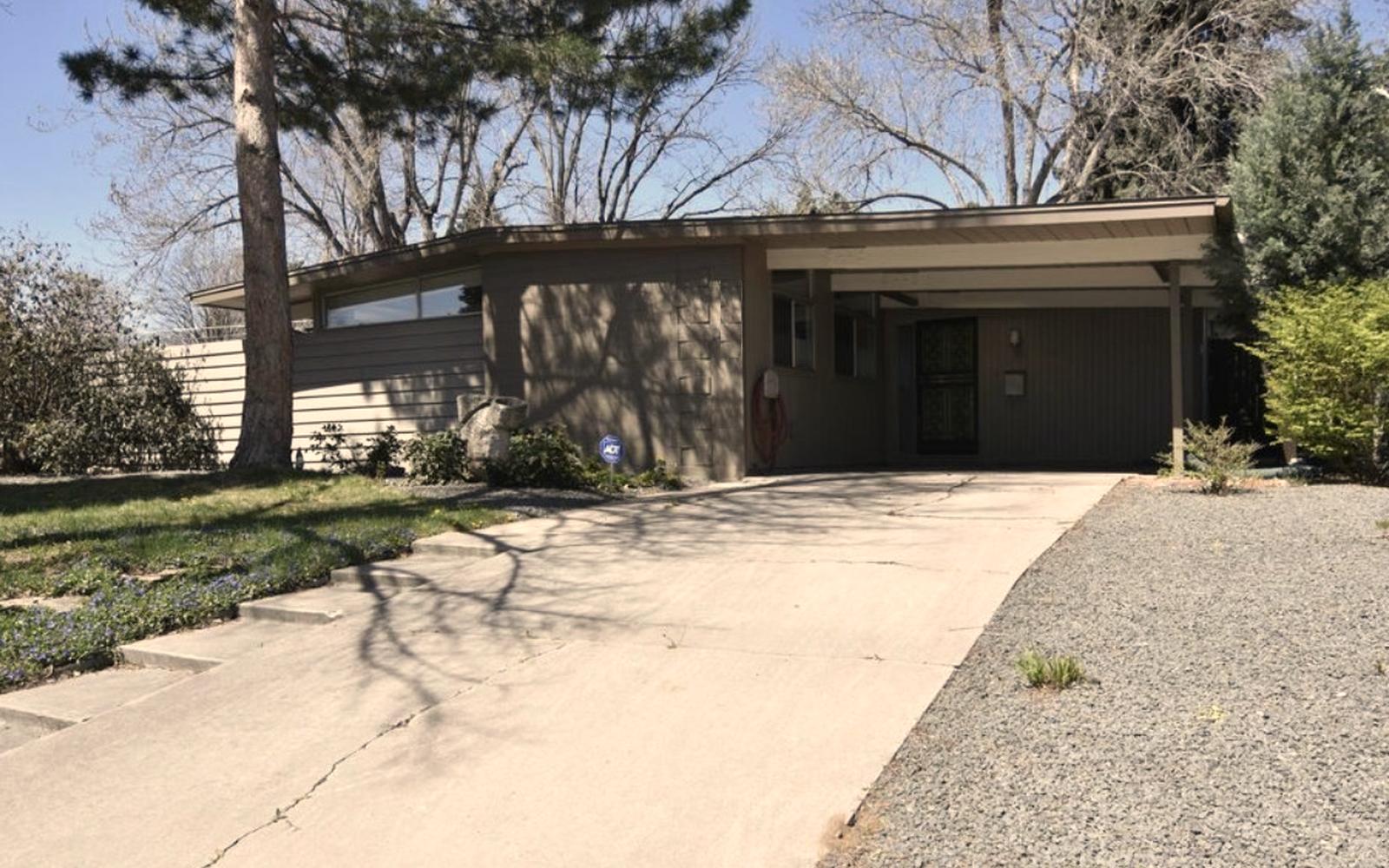 Before: the same mid-century home in faded gray-brown paint