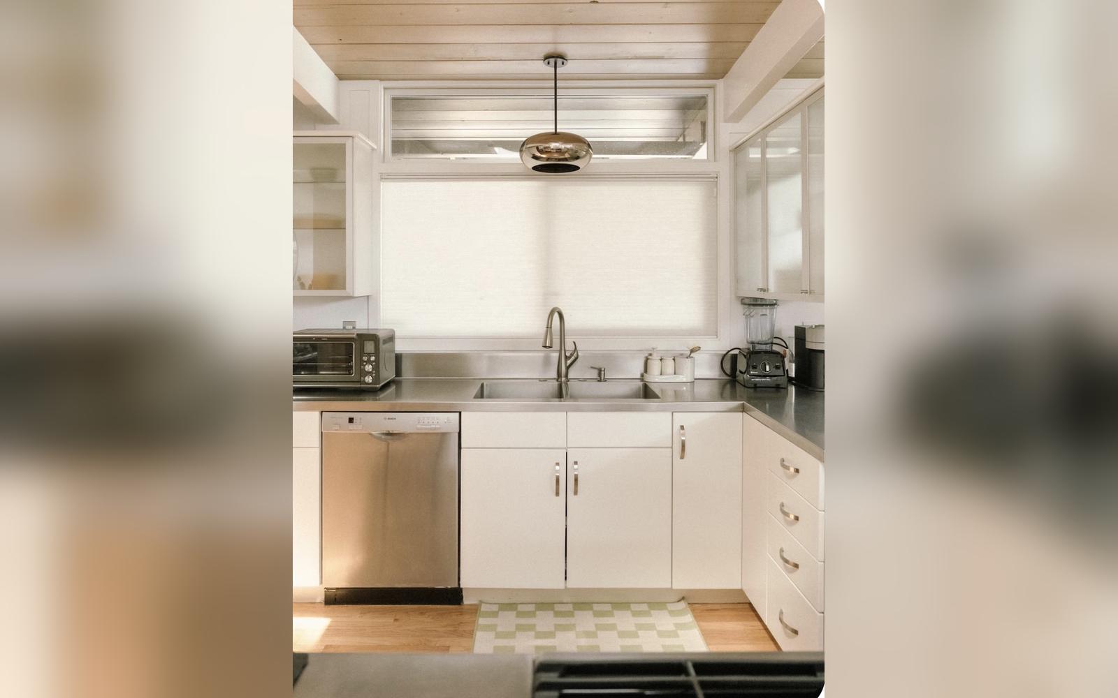 Bright white kitchen with refinished cabinets and stainless counters, by JEI Painting