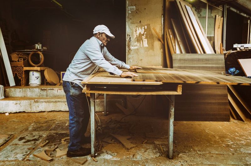 Carpenter working with wood in a workshop