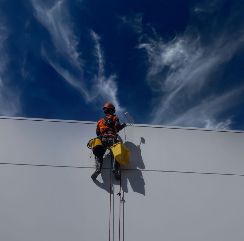Painter working on a commercial building exterior