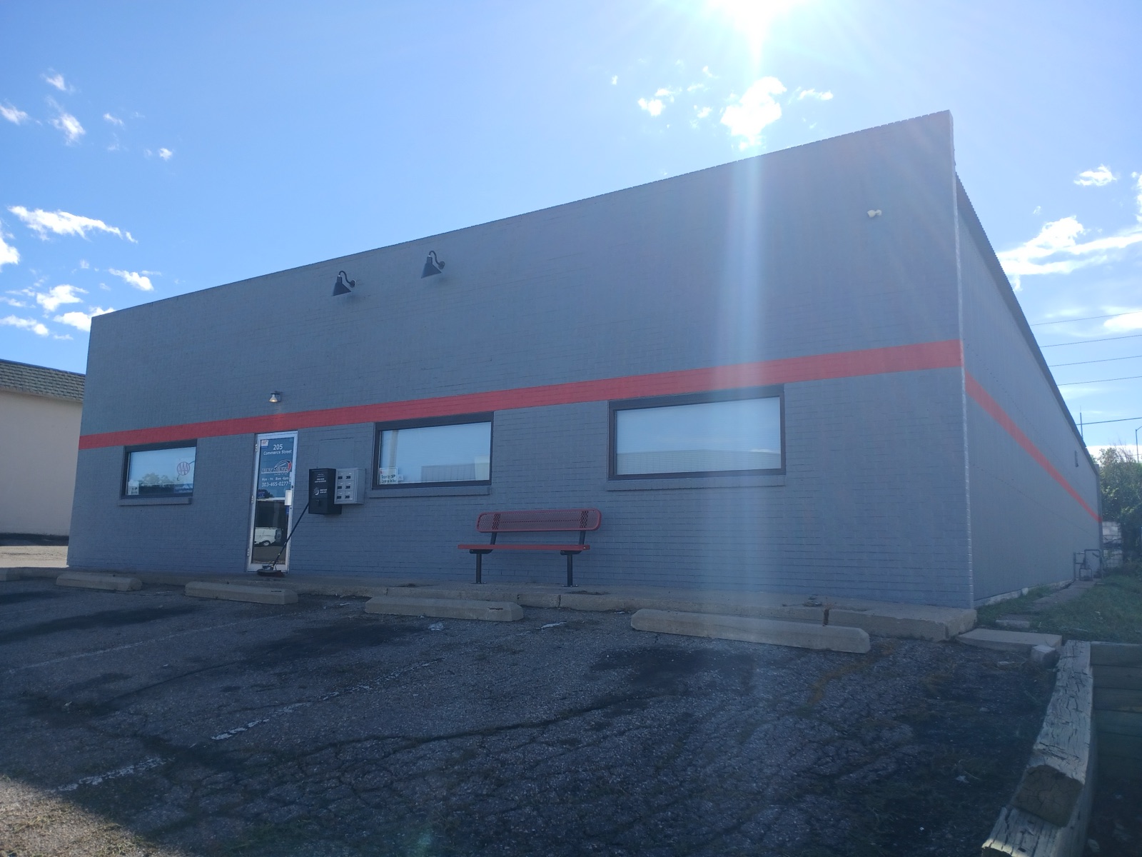 After: repainted commercial building with fresh accent stripe