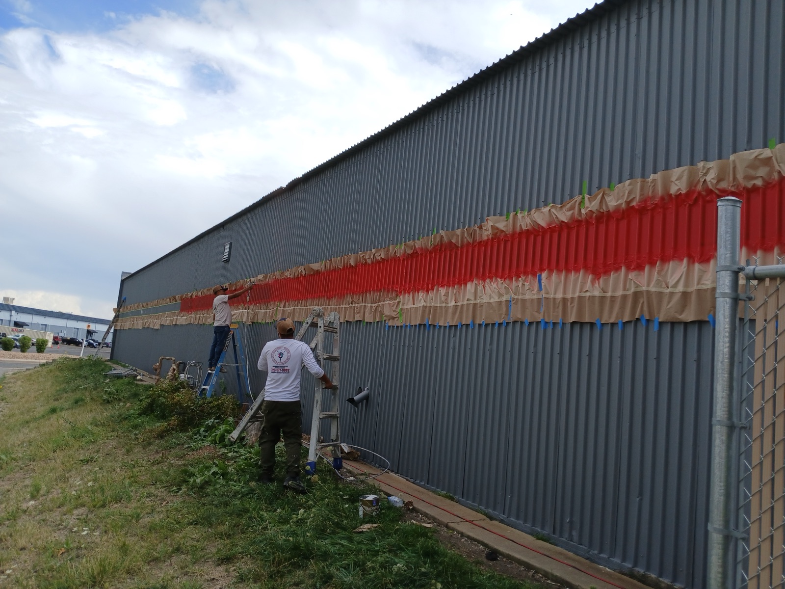 In progress: the JEI crew masking and spraying a commercial repaint