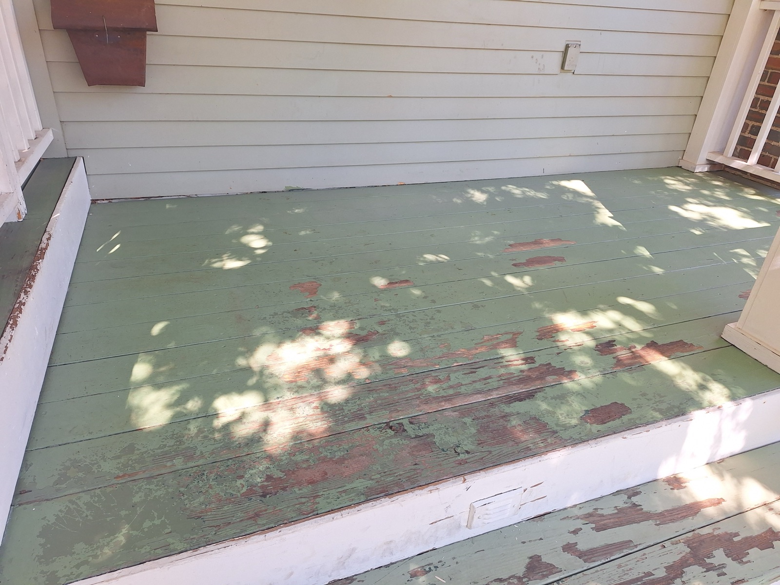 Before: worn, peeling green porch deck