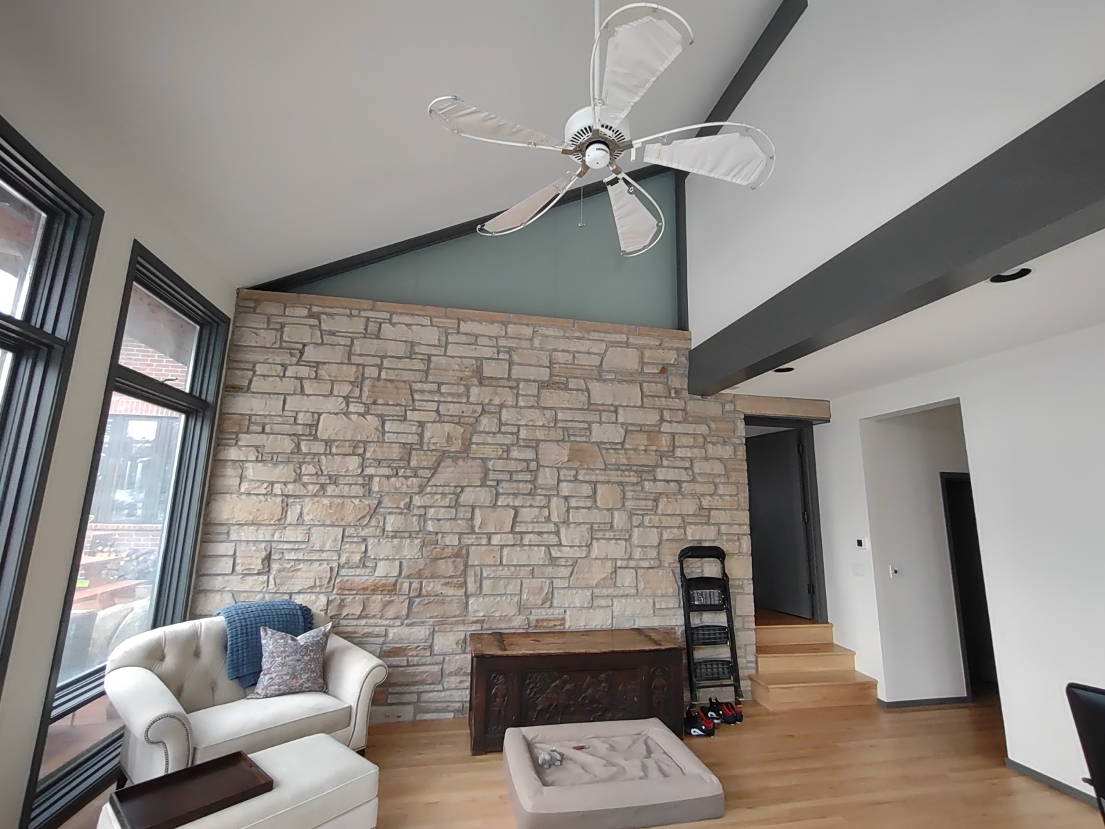 Open-concept modern interior with stone wall, painted by JEI Painting