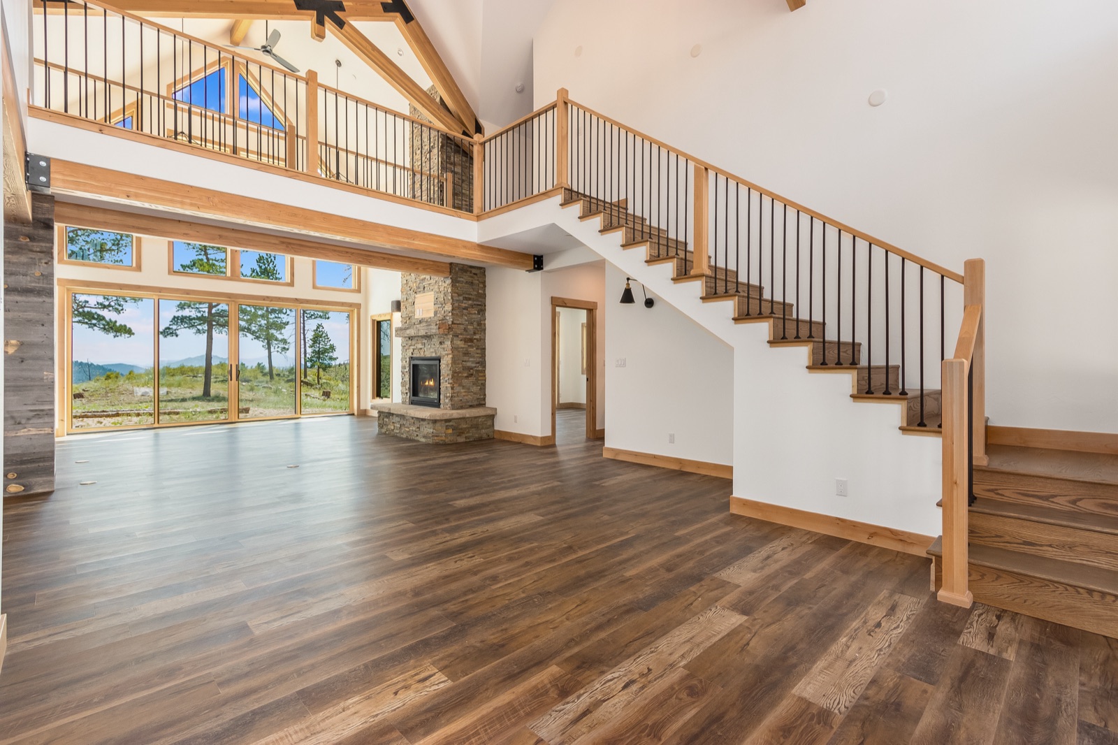 Vaulted great room with stone fireplace and mountain views, painted by JEI Painting